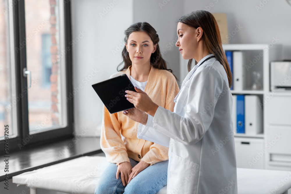 medicine, healthcare and people concept - female doctor with tablet pc computer talking to woman patient at hospital medicine, healthcare and people concept - female doctor with tablet pc computer talking to woman patient at hospital