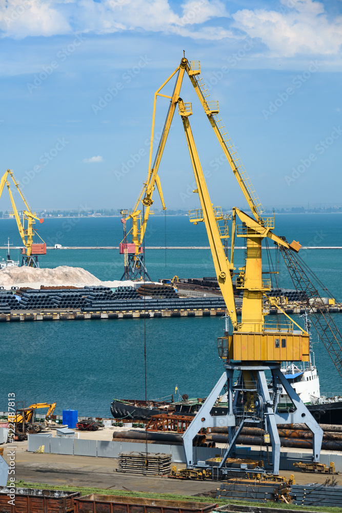industrial seaport infrastructure, sea, cranes and raw materials, metal structures and ship, the concept of marine cargo transportation industrial seaport infrastructure, sea, cranes and raw materials, metal structures and ship, the concept of marine cargo transportation