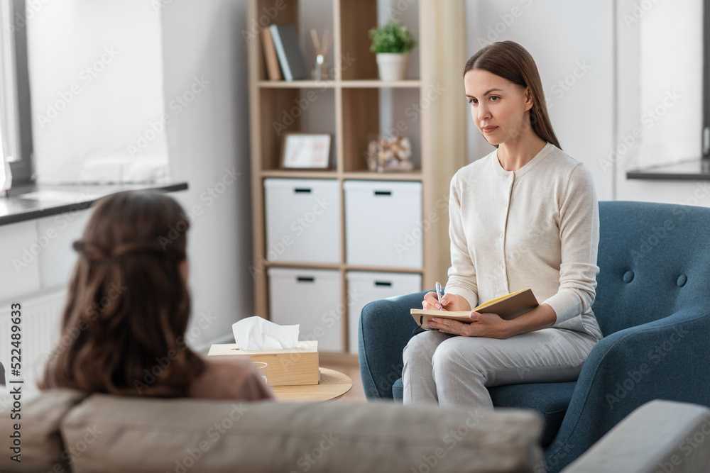 psychology, mental health and people concept - psychologist with notebook and woman patient at psychotherapy session psychology, mental health and people concept - psychologist with notebook and woman patient at psychotherapy session