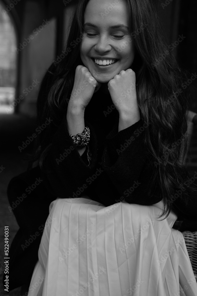 Sensual portrait of a young brunette in a white dress. Girl in a autumn wear is sitting in a chair Sensual portrait of a young brunette in a white dress. Girl in a autumn wear is sitting in a chair