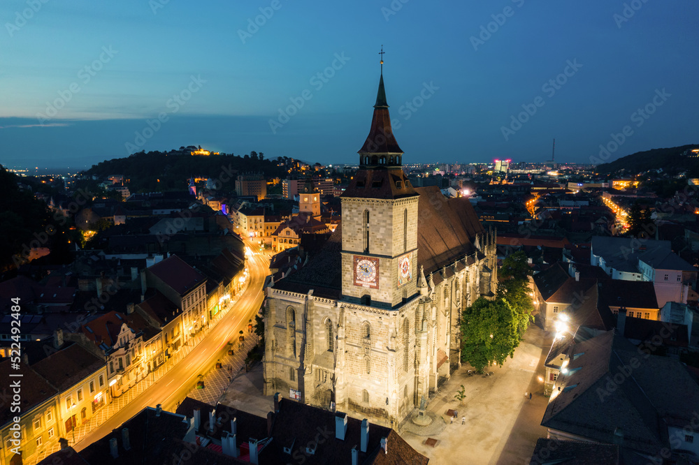 Aerial drone view of The Black Church in Brasov at night, Romania