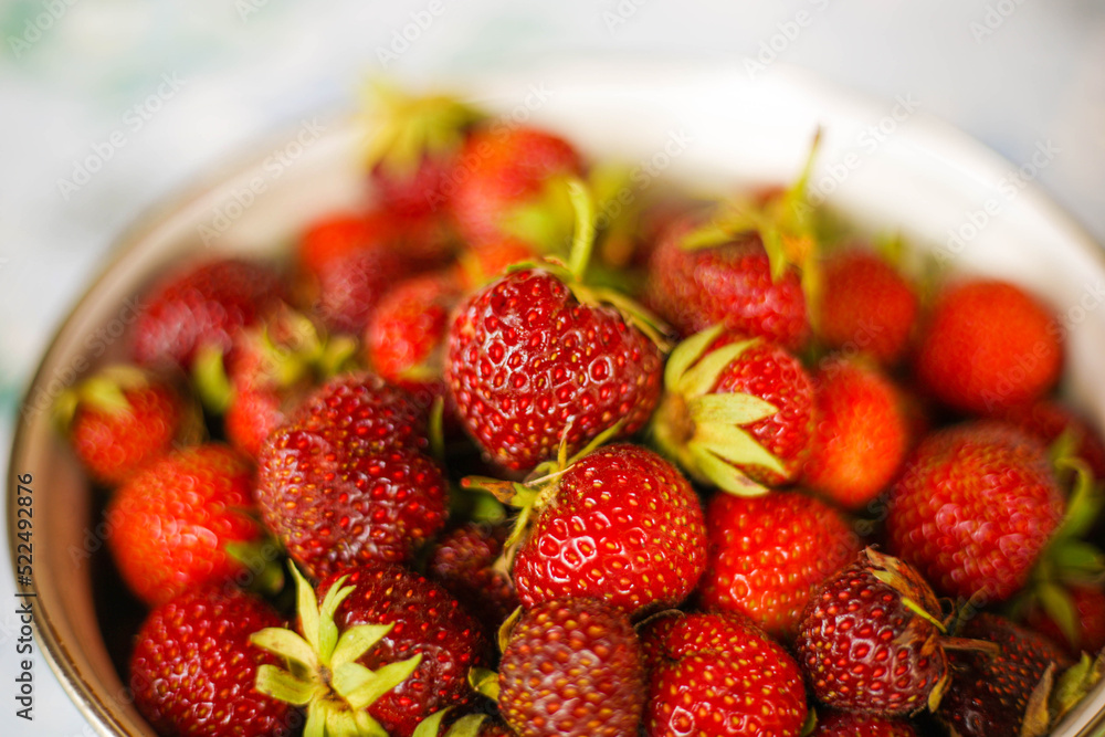 Fresh strawberries in a metal saucepan on a light background Fresh strawberries in a metal saucepan on a light background