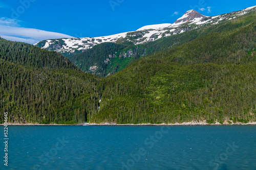 A view of wooded sides of the Chilkoot Inlet close to Skagway, Alaska on a summers evening