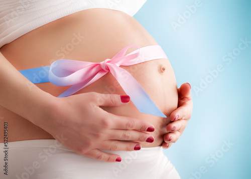 Wallpaper Mural Pregnant belly with colored ribbon. Third trimester. Torontodigital.ca