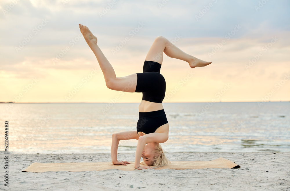 fitness, sport, and healthy lifestyle concept - woman doing yoga headstand on beach over sunset fitness, sport, and healthy lifestyle concept - woman doing yoga headstand on beach over sunset