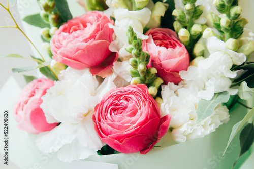 A bouquet of flowers  roses  white carnations  greenery close-up. Floral background  front view