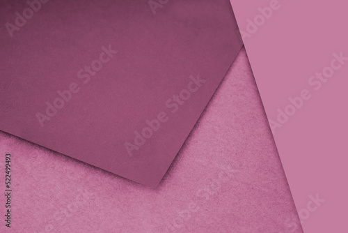 Plain and Textured pink peach purple papers randomly laying to form M like pattern and triangle for creative cover design idea