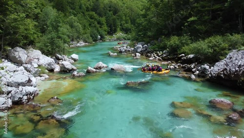Soca Valley, Slovenia - 4K Aerial shot of white water rafting on River Soca. Following whitewater rafting boat going down the emerald alpine river Soca on a bright summer day
 photo