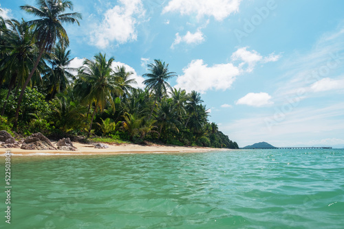 Thailand beach with palm trees and blue sky