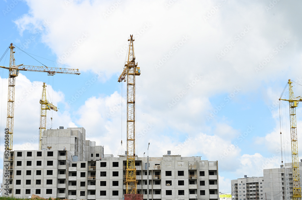 Construction an new apartment building. Construction site with many tower cranes