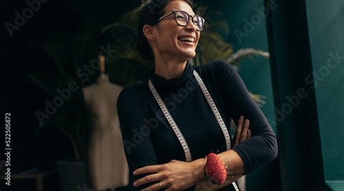 Tablou pe pânză Female fashion designer laughing in her studio