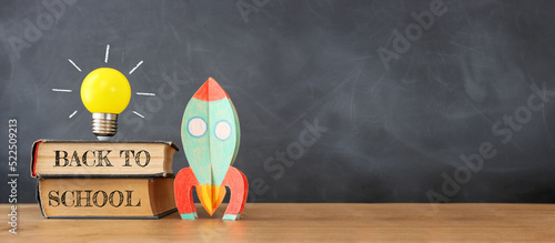 education. Back to school concept over wooden table and blackboard background