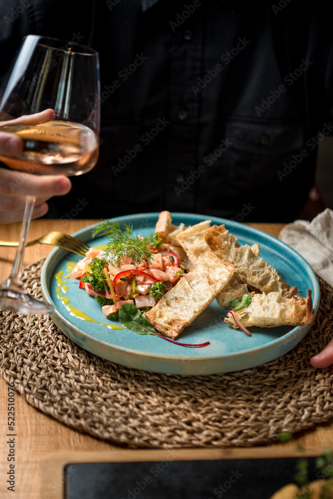 Man have delicious meal of seafood salad and rose wine Man have delicious meal of seafood salad and rose wine