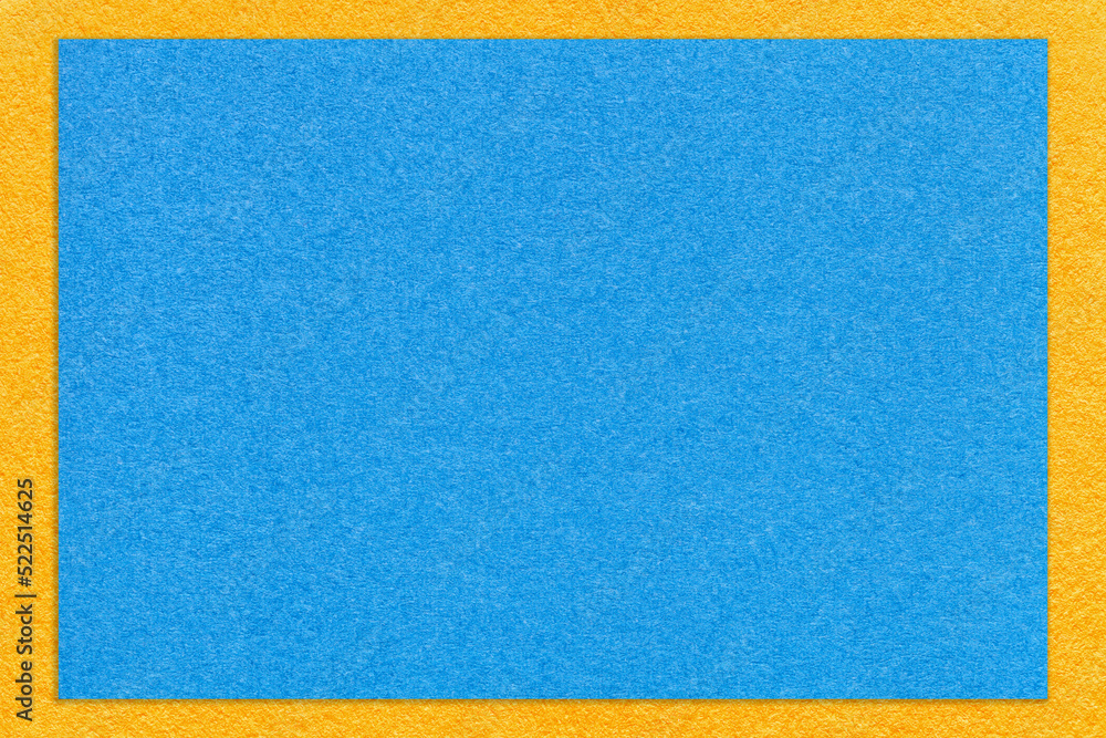 Texture of craft light blue color paper background with yellow border, macro. Structure of vintage cardboard Texture of craft light blue color paper background with yellow border, macro. Structure of vintage cardboard
