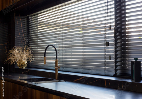Foto Wooden blinds black color closeup on the window