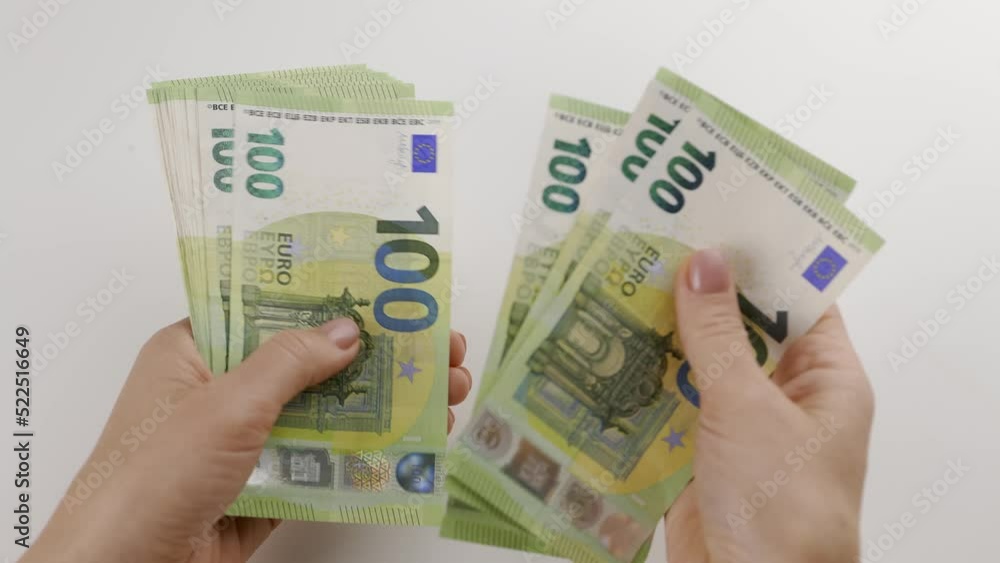 Female hands counting one hundred euro banknotes with copy space. Female hands counting one hundred euro banknotes with copy space.