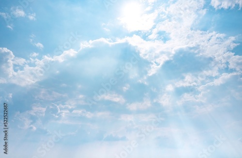 Blue sky, white clouds and light rays