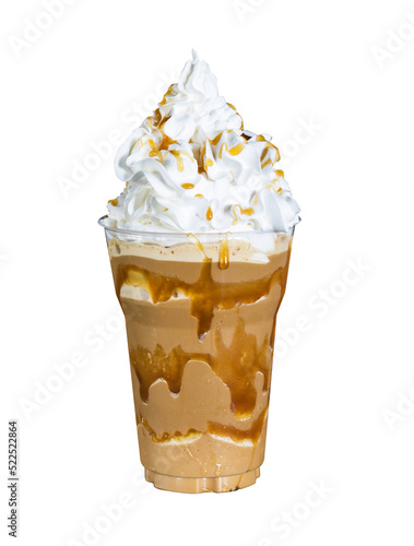 Caramel milk smoothie with cream in plastic cup. Healthy drink to refresh and cool down.
