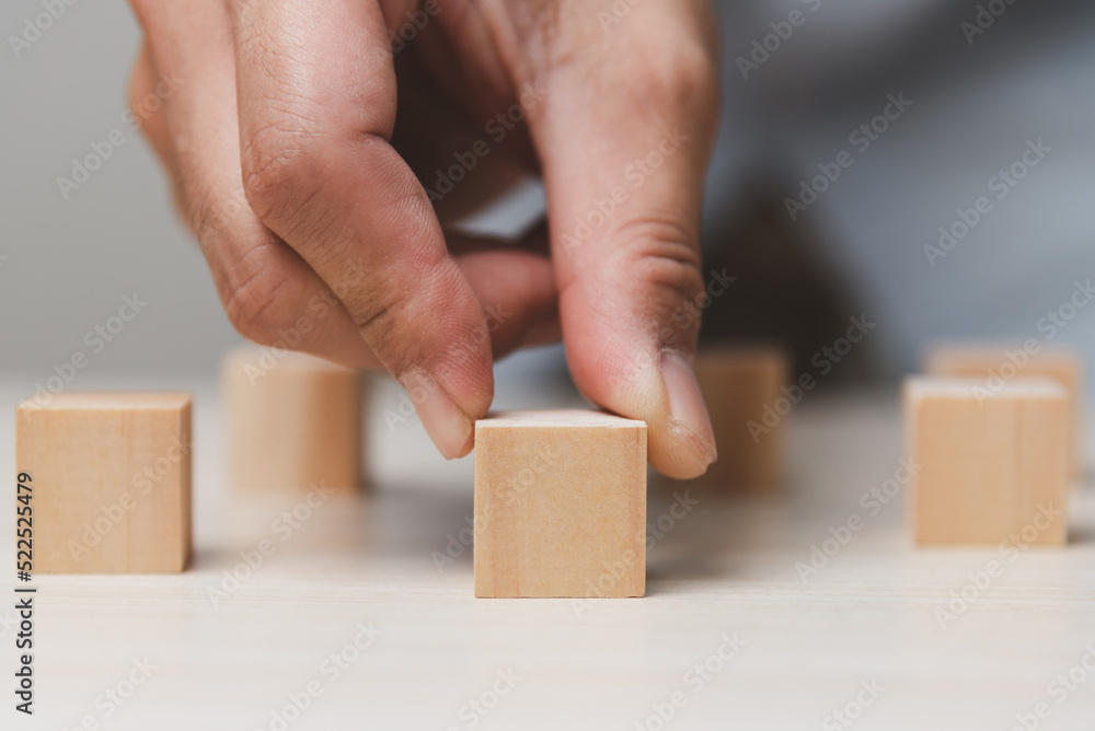 Hand holding wood cube block.Business growth success concept. Hand holding wood cube block.Business growth success concept.