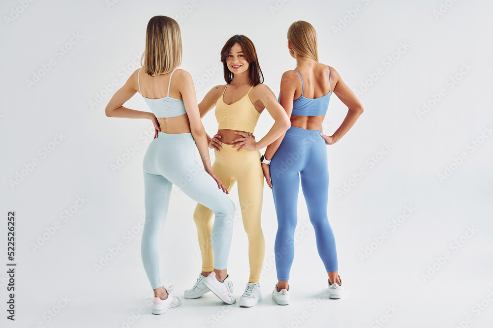 © standret - Slim body type. Beautiful women in sportive clothes is indoors in the studio