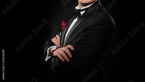 Element of the image of a man dressed in a tuxedo on a dark background.