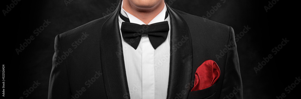 Element of the image of a man dressed in a tuxedo on a dark background. - obrazy, fototapety, plakaty 