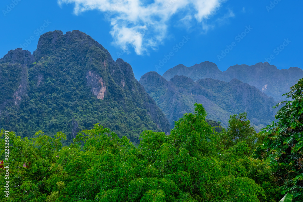 Vang Vieng Laos a beautiful city on the river with huge rising mountains and slow flowing river. 