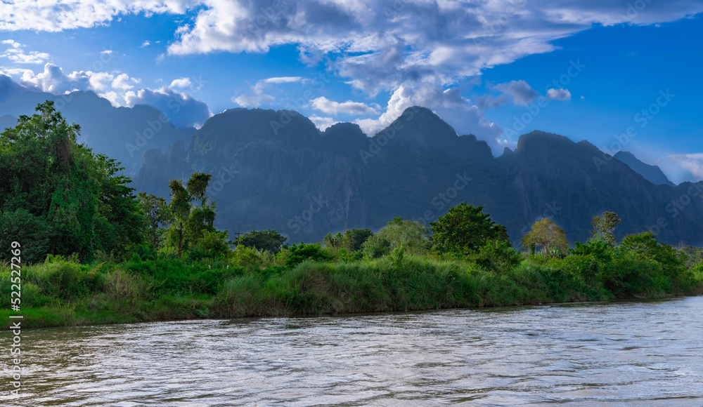 Vang Vieng Laos a beautiful city on the river with huge rising mountains and slow flowing river. Vang Vieng Laos a beautiful city on the river with huge rising mountains and slow flowing river.