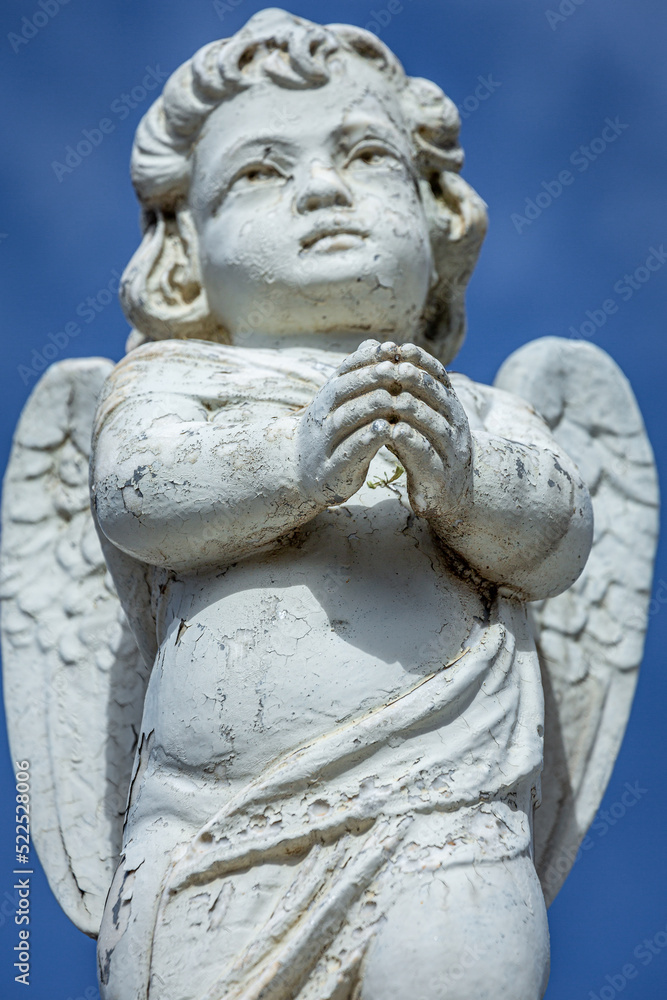 Seraphim angel praying with hands clasped for faith and hope of better days