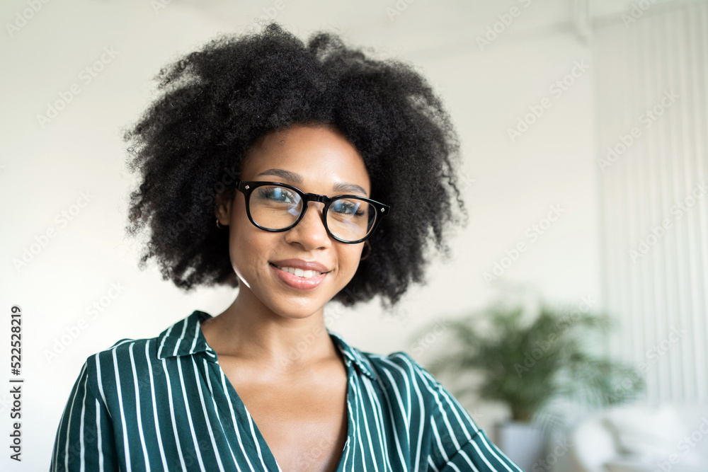 Portrait of a business woman in an office with glasses looking at the camera Portrait of a business woman in an office with glasses looking at the camera