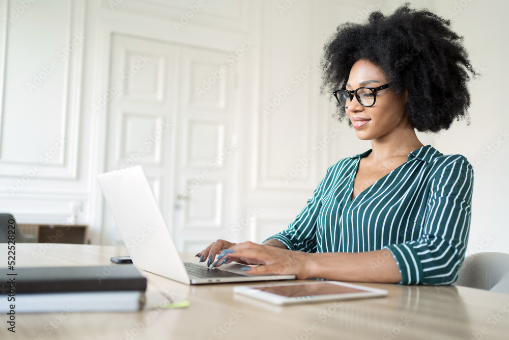The receptionist is a woman working in an office using a laptop in a finance company The receptionist is a woman working in an office using a laptop in a finance company
