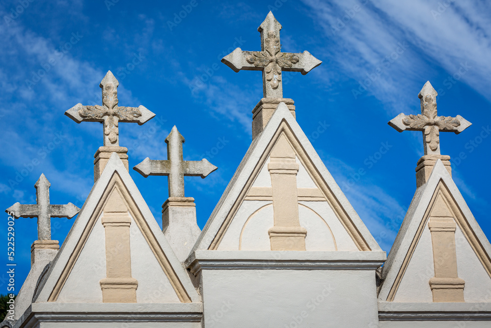 Pattern of crosses tombstones in Cemetery in a row and clear sky Pattern of crosses tombstones in Cemetery in a row and clear sky