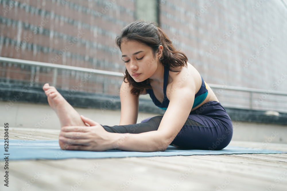 Young attractive woman doing stretching yoga exercise in the park. Young attractive woman doing stretching yoga exercise in the park.
