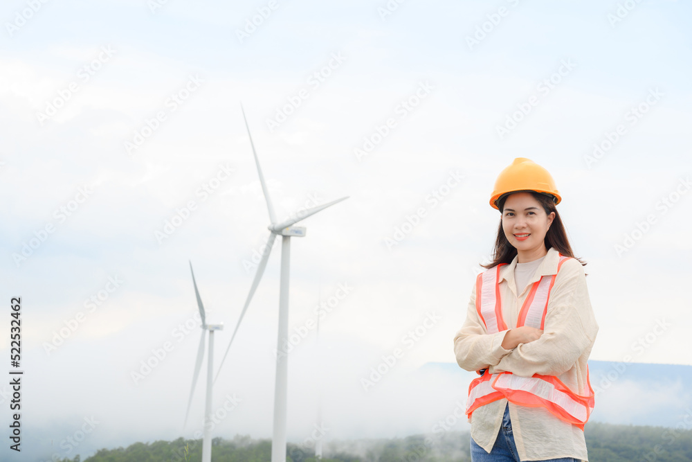 A woman worker inspects wind turbines and progress inspects wind turbines at a renewable energy mountain power station. A woman worker inspects wind turbines and progress inspects wind turbines at a renewable energy mountain power station.