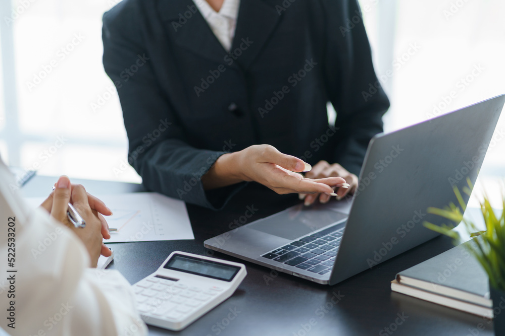 Close-up of a group of business people having a meeting Brainstorm together to come up with a plan for working on a laptop planning marketing strategies, analyzing balance sheets, income statements. Close-up of a group of business people having a meeting Brainstorm together to come up with a plan for working on a laptop planning marketing strategies, analyzing balance sheets, income statements.