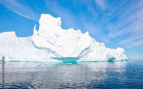 Wallpaper Mural Melting giant icebergs by the coast of Greenland, on a beautiful summer day - Melting of a iceberg and pouring water into the sea - Greenland Torontodigital.ca