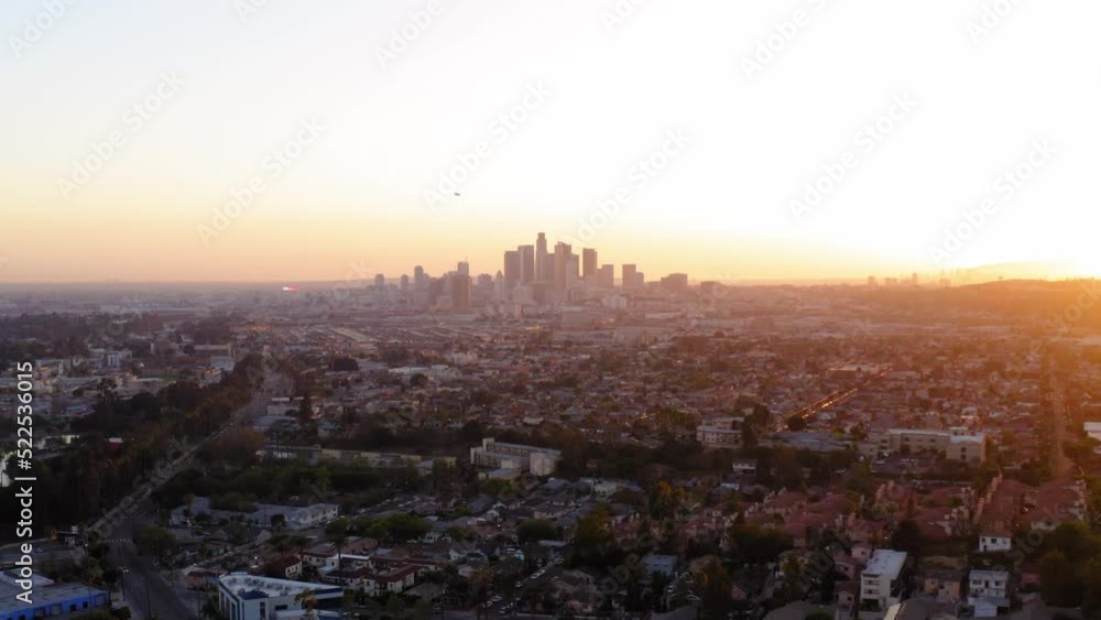 Aerial Backward Shot Of Residential Buildings Against Clear Sky In City During Sunset - Los Angeles, California Aerial Backward Shot Of Residential Buildings Against Clear Sky In City During Sunset - Los Angeles, California
