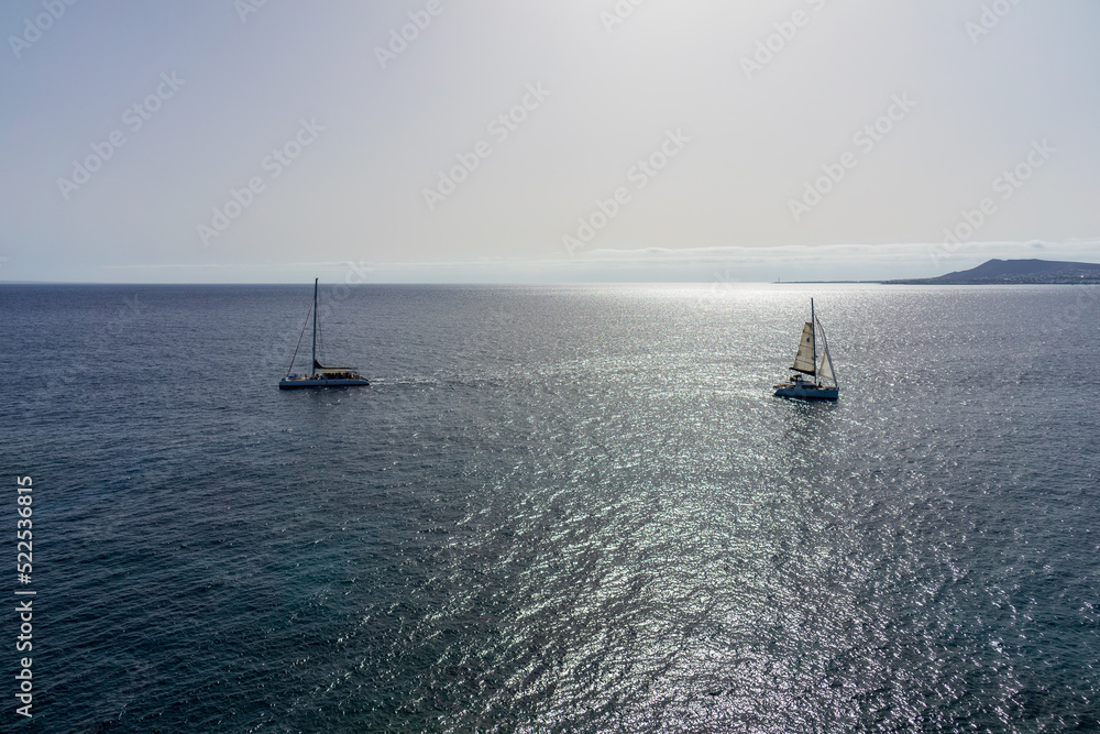 Obraz premium Seascape with sun reflection. Pleasure yachts in the sea.