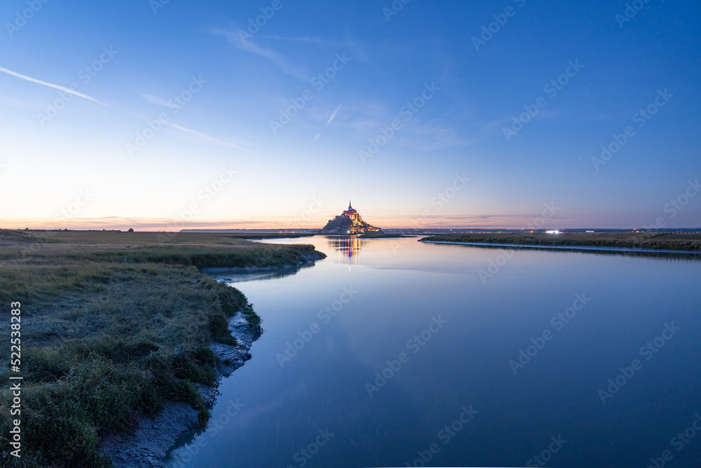 Sunset over Mont Saint Michel, monumental architecture of thousands years in France