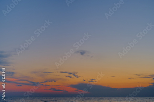 Sunset in the sea. Background or screensaver idea. Image has grain or blur  noise  and blurry focus when viewed at full resolution.  Shallow depth of field  slight motion blur 