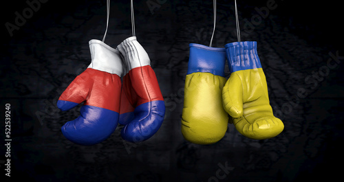 Hanging boxing gloves with the Russian and ukrainian flags illustrate the tensions between the two countries - 3d illustration © Christoph Burgstedt