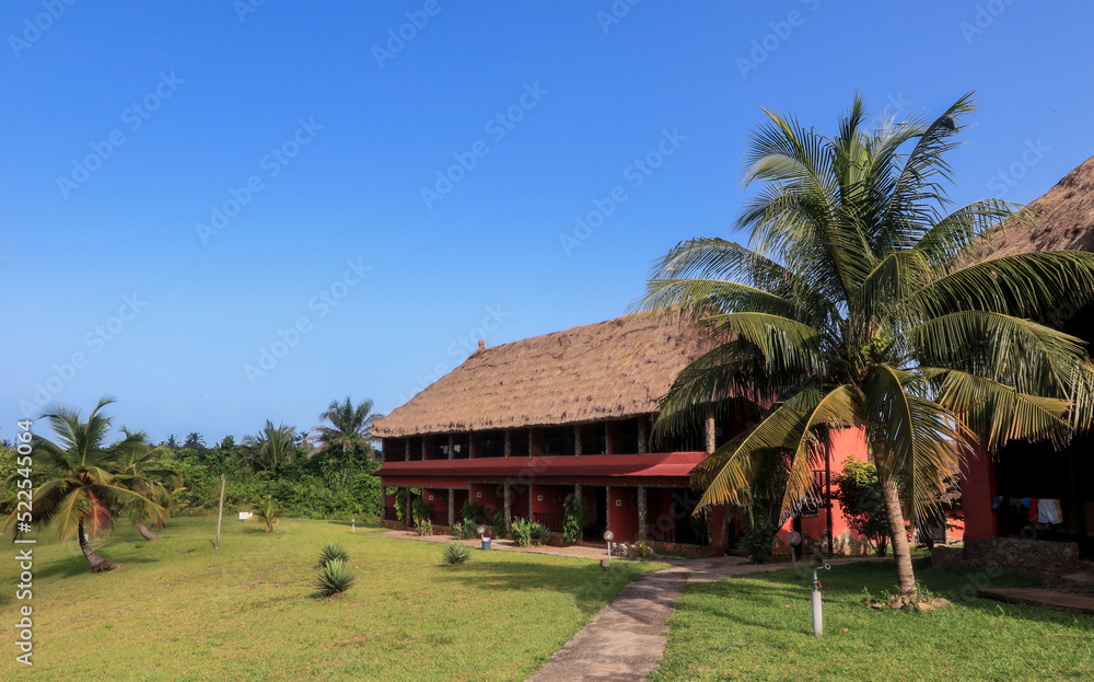 Traditional African Houses on the Axim Tropical Beach in Ghana, West Africa Traditional African Houses on the Axim Tropical Beach in Ghana, West Africa