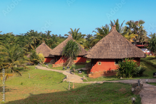 Quadro su tela Traditional African Houses on the Axim Tropical Beach in Ghana, West Africa