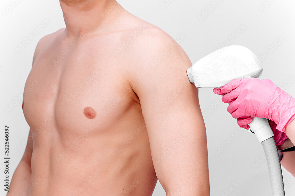 Shoulder hair removal procedure by laser hair removal on a white ...