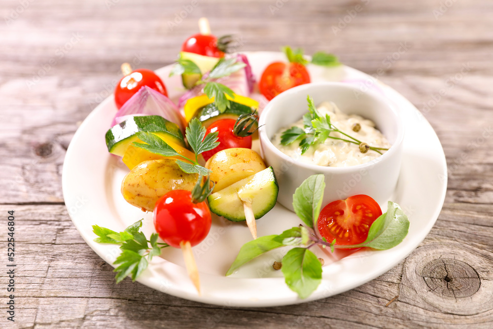 vegetable skewer and dipping sauce on plate vegetable skewer and dipping sauce on plate