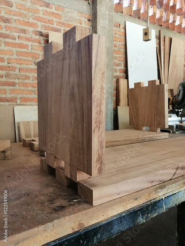wood piece with dovetail attachment. Dovetail joint on working table. Chisel and wood chips. photo