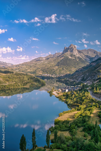 Vertical landscape of a mountain reflected in a lake on a sunny summer morning