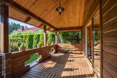 Fotografie interior of empty hall veranda in wooden village vacation home with garden chair