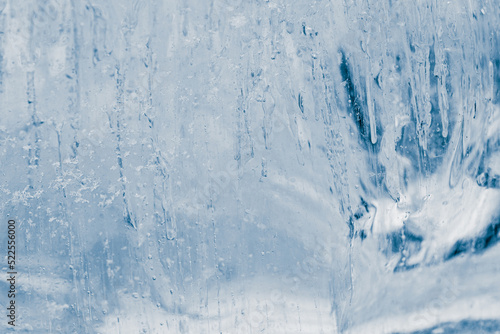 Block of pure transparent ice in cold blue tones. Ice structure.