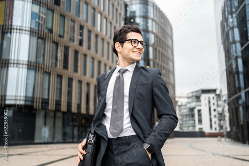 Businessman man with glasses goes to work in the office in a business suit